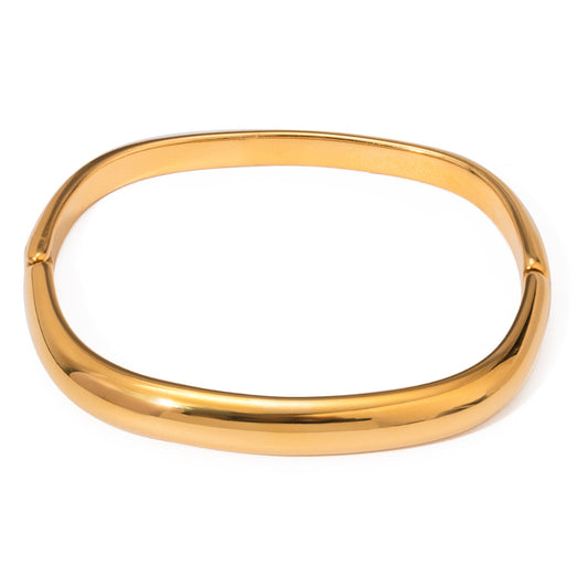 Gold bangle on a white background