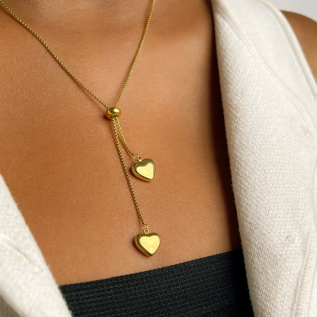 Gold heart lariat necklace on model