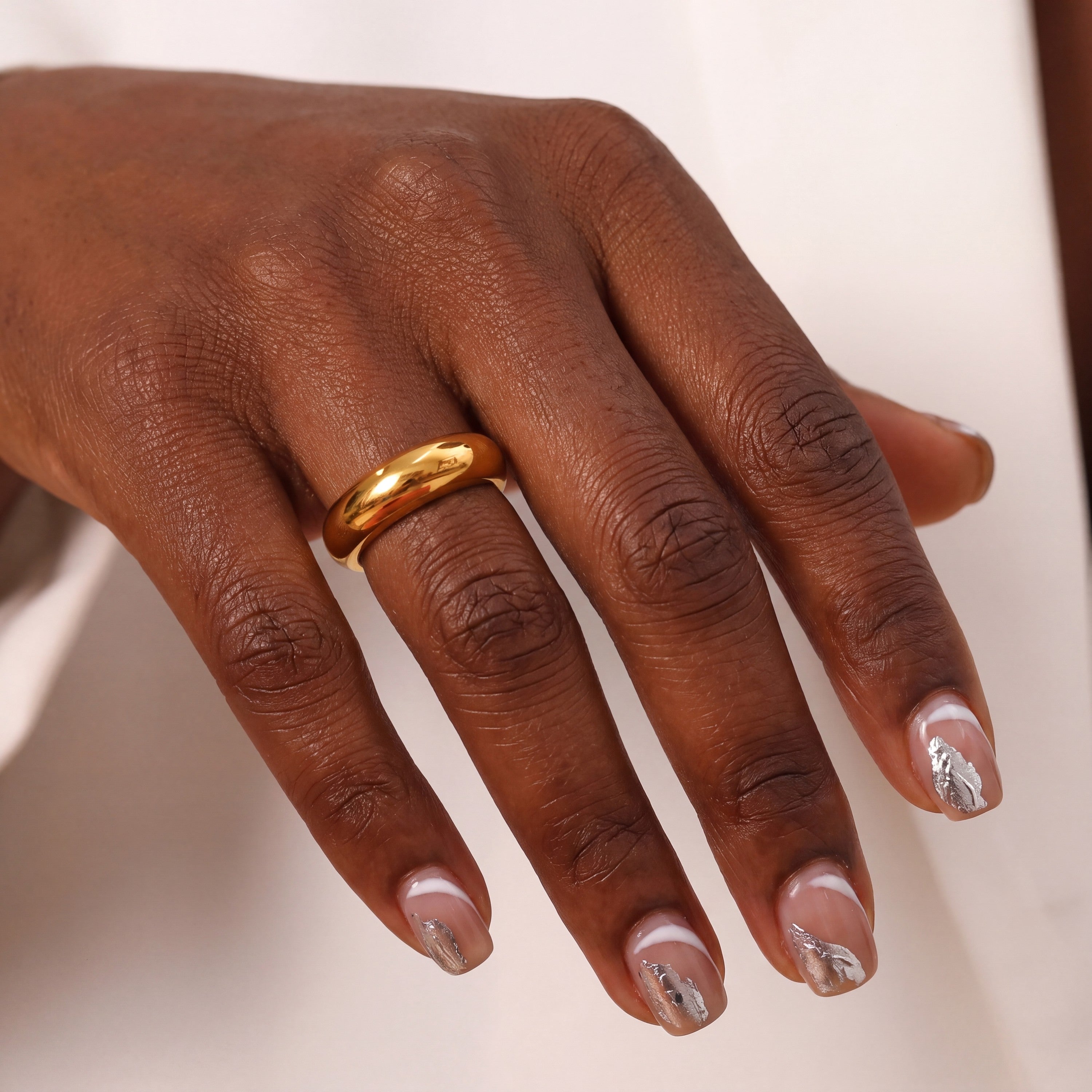 Gold dome ring on hand