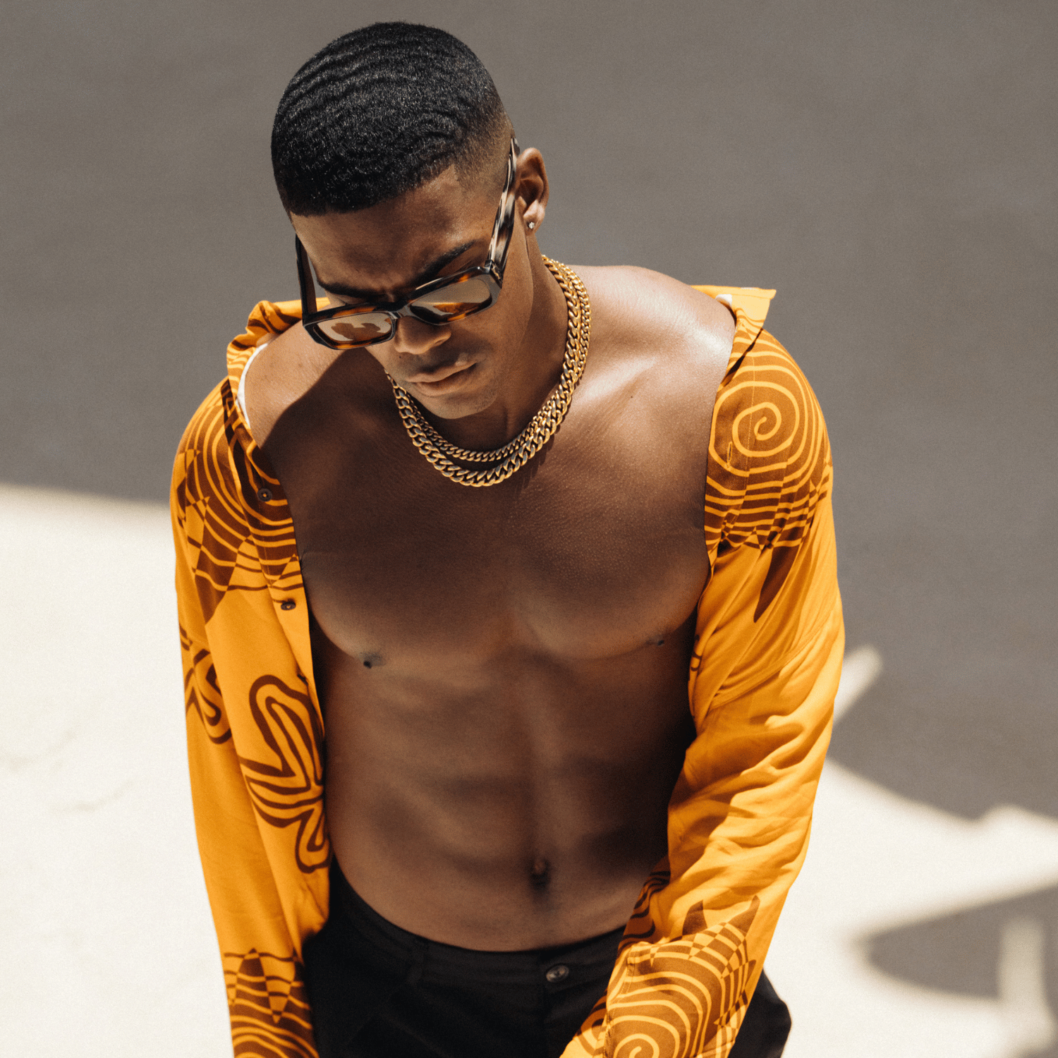 Man wearing a 12mm gold Cuban link chain, ITURA Man collection